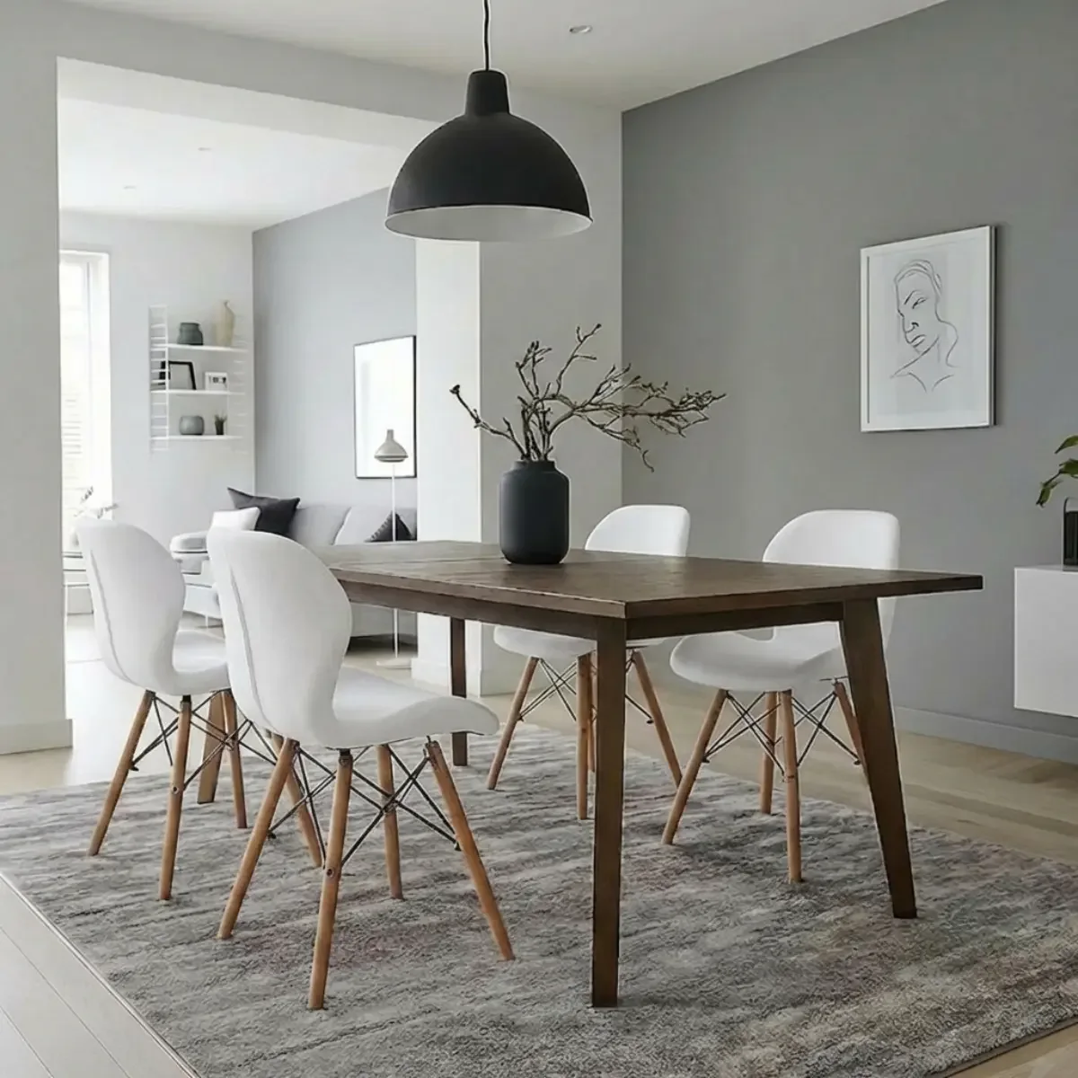 Dining room with a wooden table and white molded chairs with wooden legs
